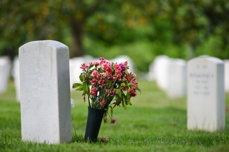 Flowers next to headstone